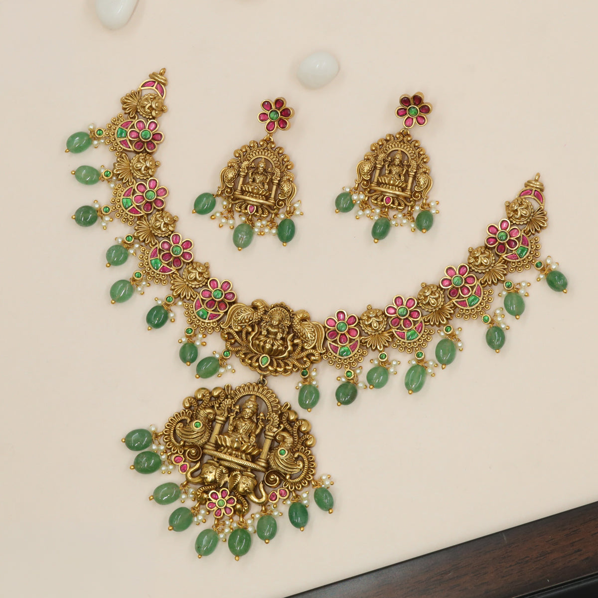 Antique Necklace Showcasing Lakshmi Figures and Curved Decorative Borders