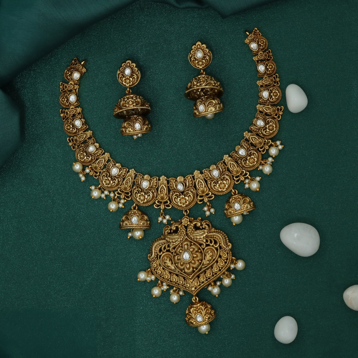 Antique Necklace Showcasing Ornate Floral Carving and Hanging Bells