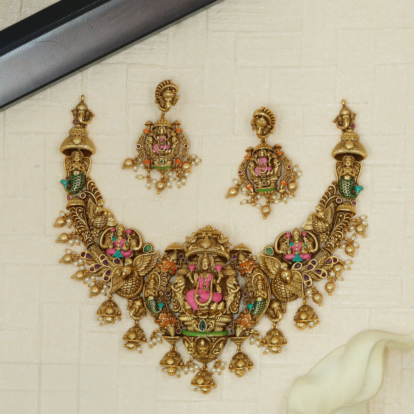 Seated Lakshmi Centrepiece with Peacock Details in an Antique Necklace