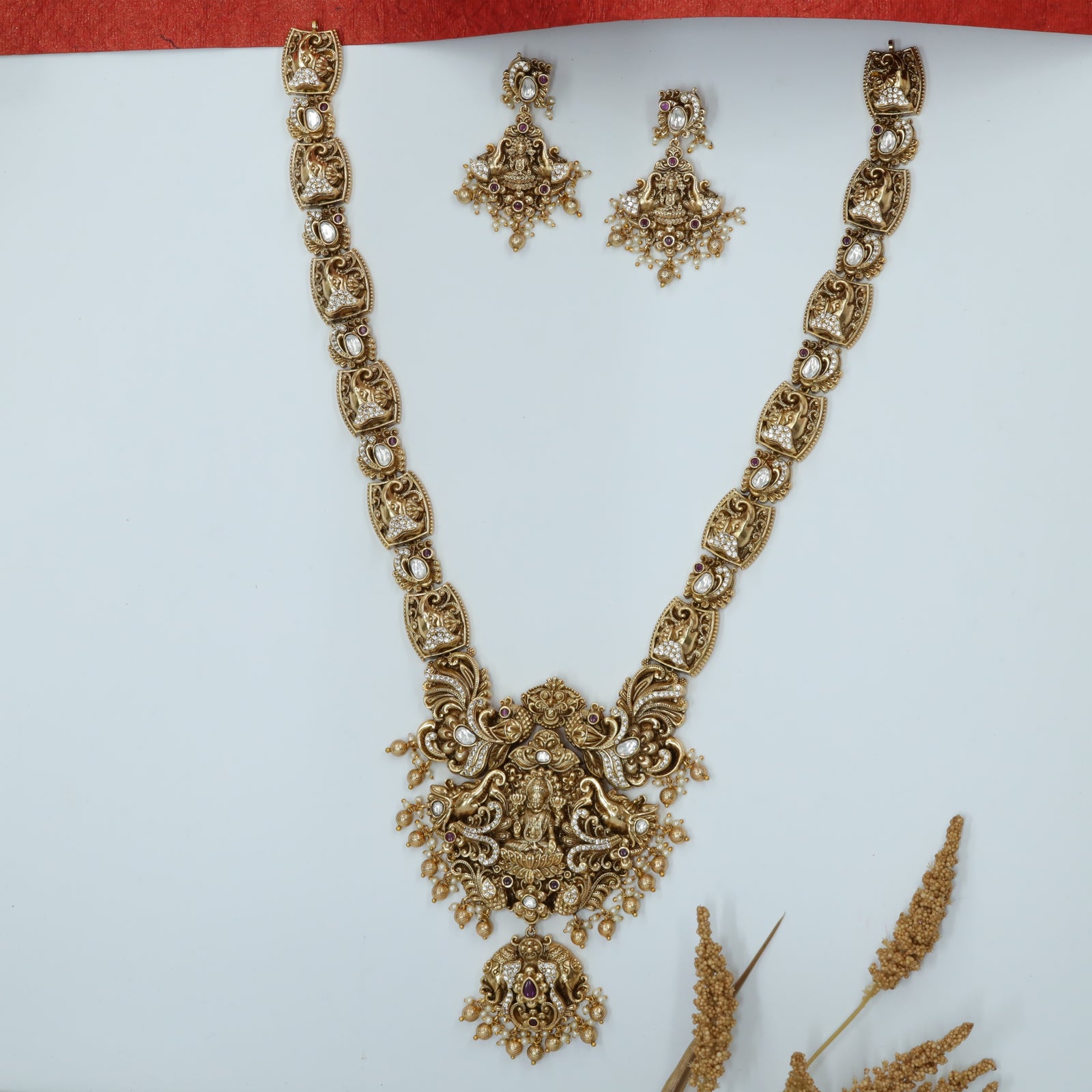 Sri Lakshmi Centre Long Haara with Gaja Relief Links and Mayura Crest Drops
