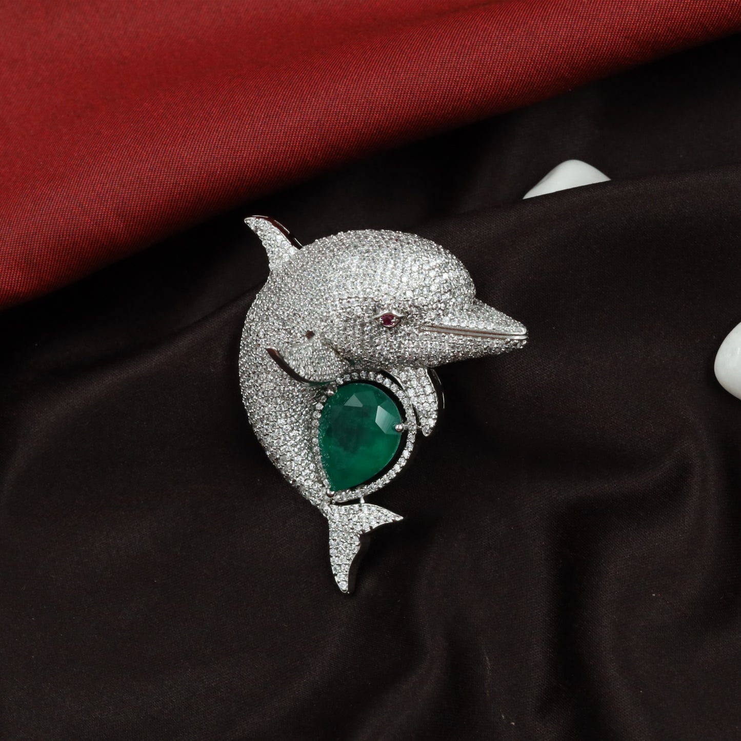 Ocean Curve Dolphin Silhouette Rhodium Brooch with Emerald Core