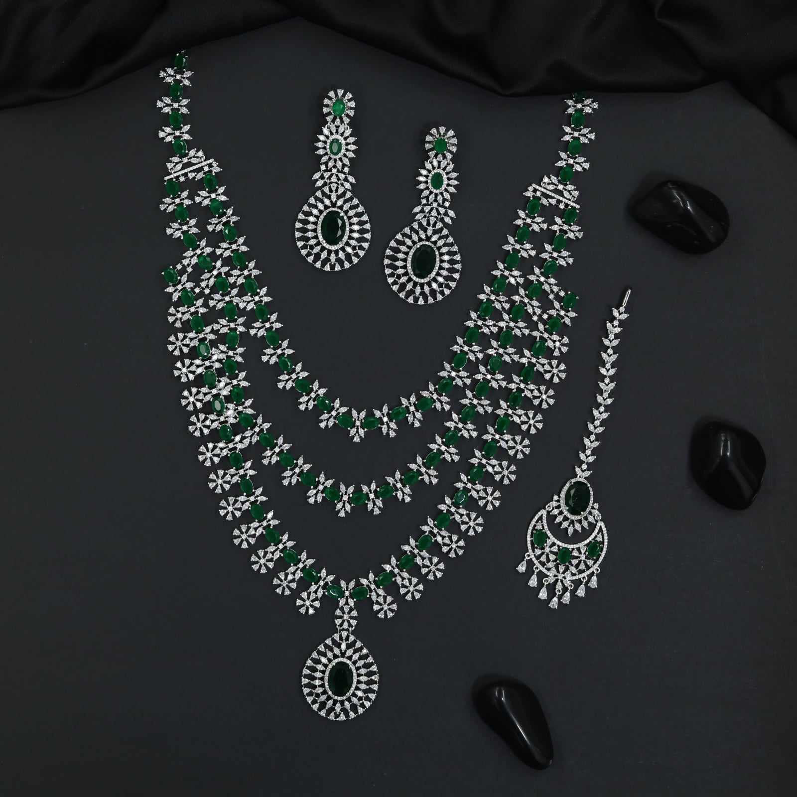 Grand long haara with floral connectors and oval pendant accents