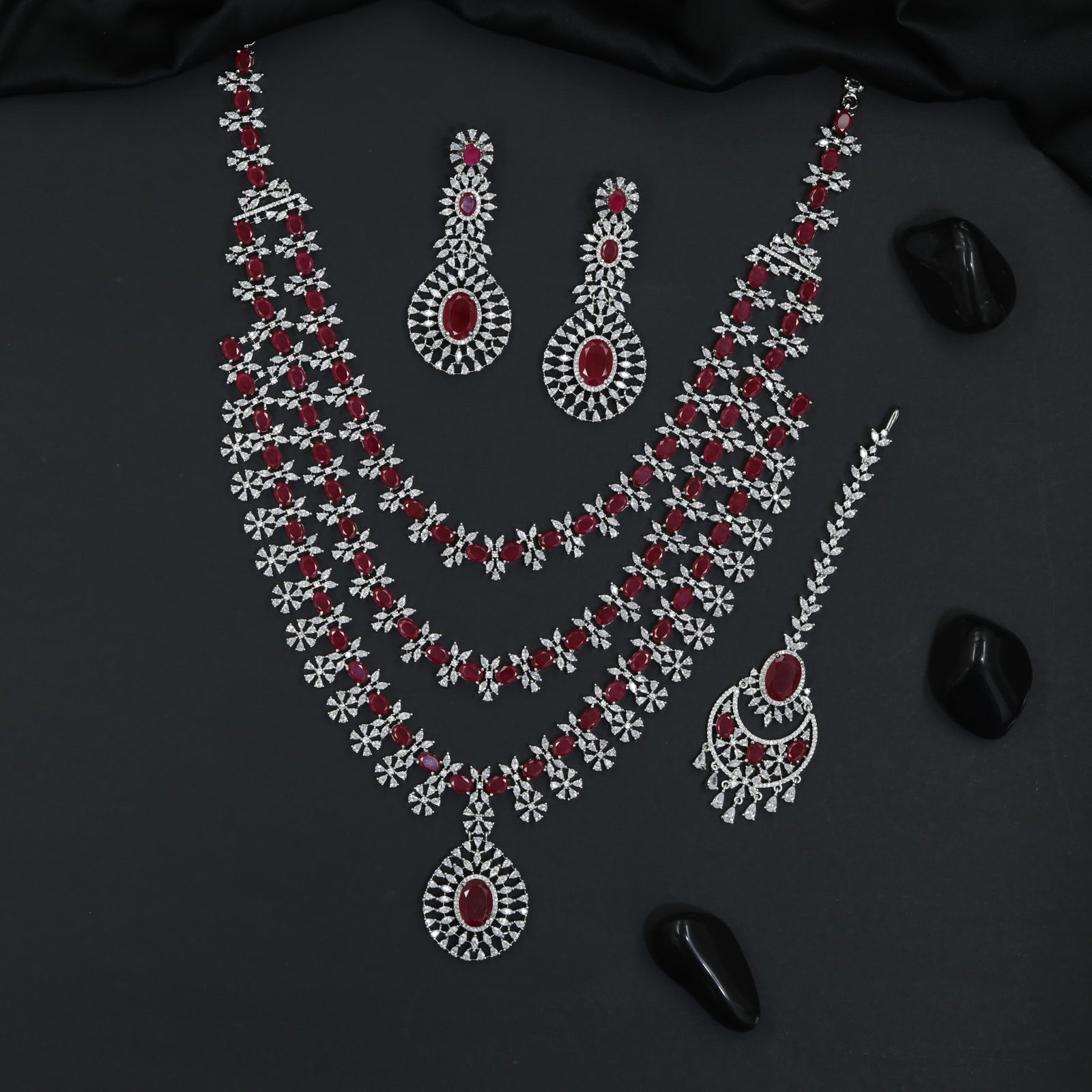 Grand long haara with floral connectors and oval pendant accents