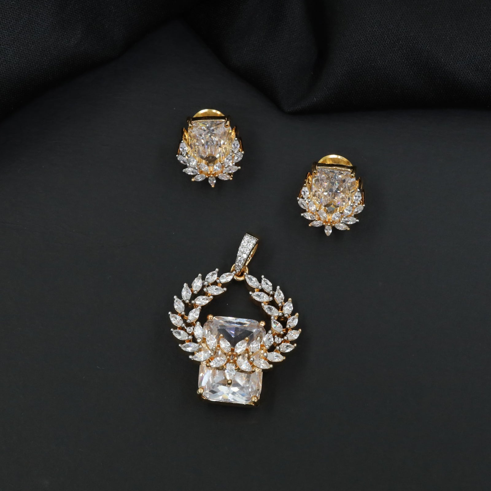 Open wreath pendant set with marquise cluster detailing and drop design