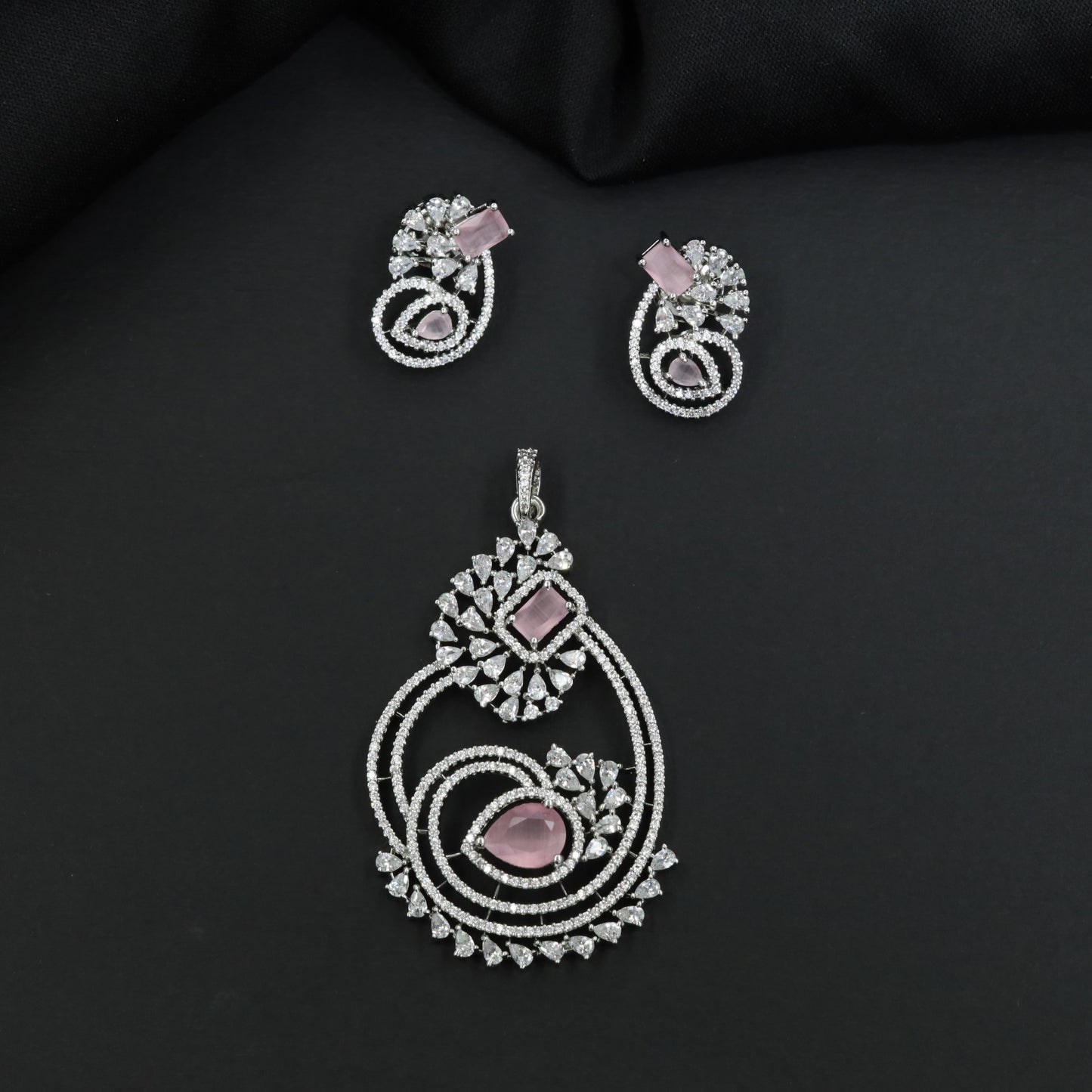 Rhodium pendant set featuring geometric floral clusters and matching studs