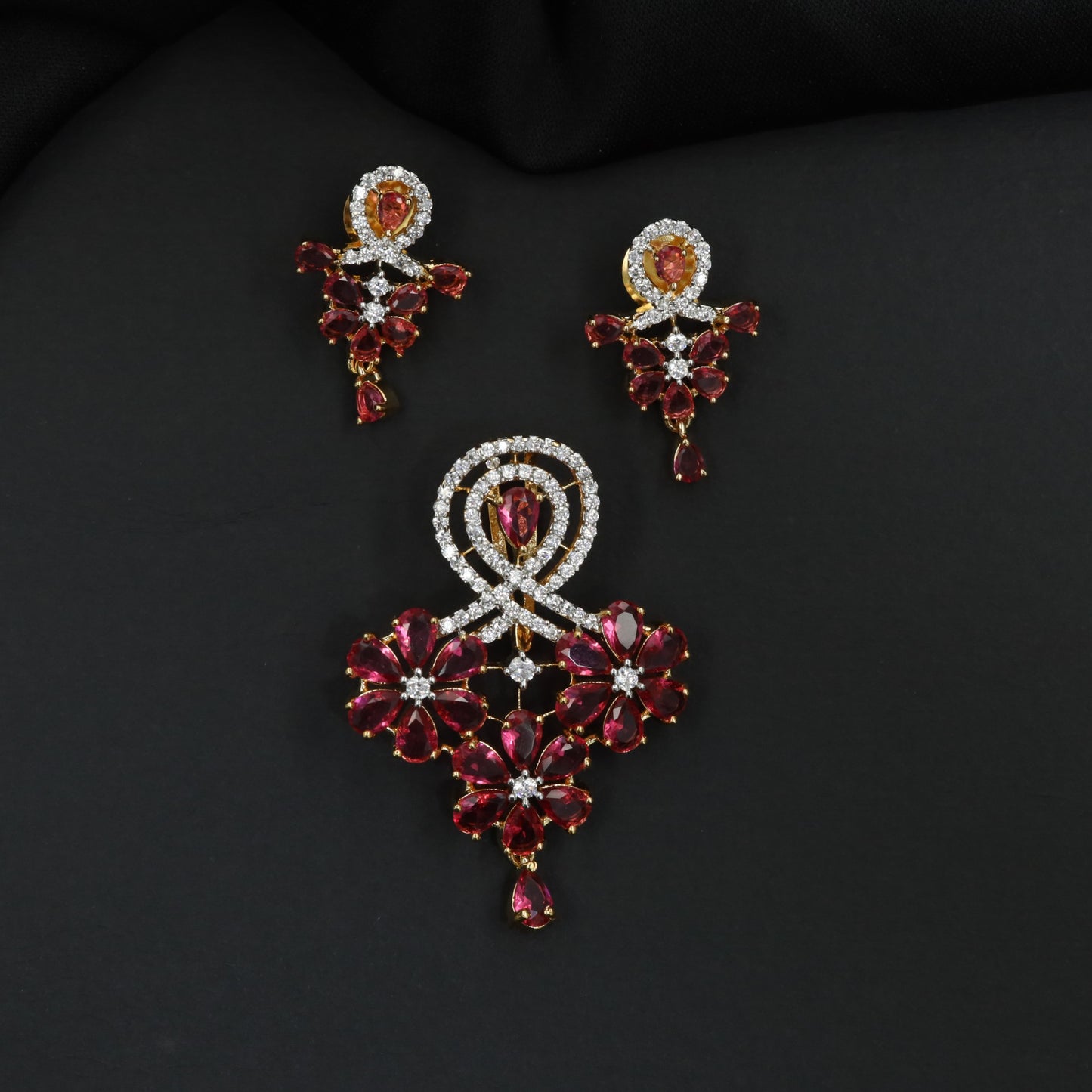 Decorative pendant set with floral craftsmanship and looped centerpiece