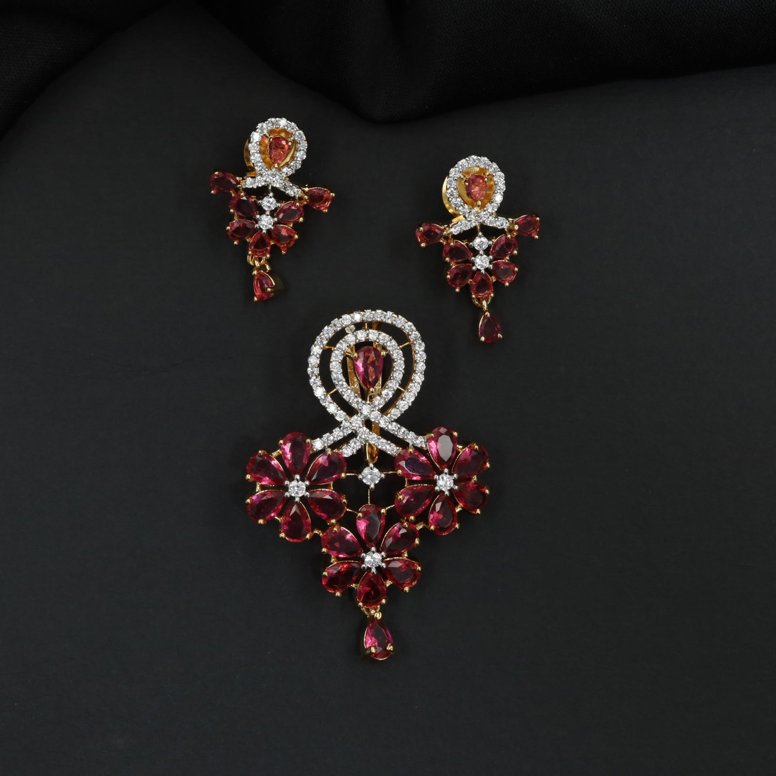 Decorative pendant set with floral craftsmanship and looped centerpiece