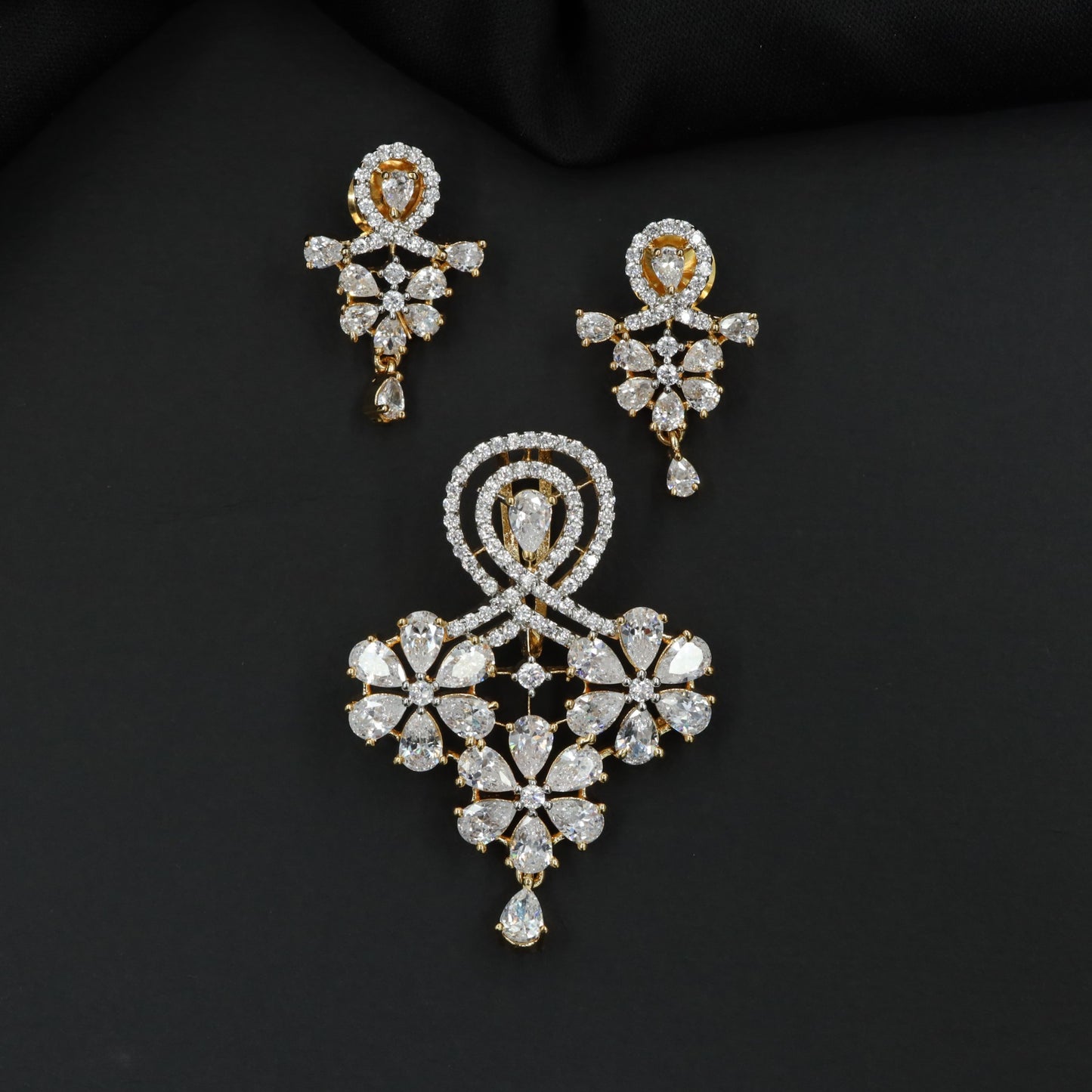 Decorative pendant set with floral craftsmanship and looped centerpiece