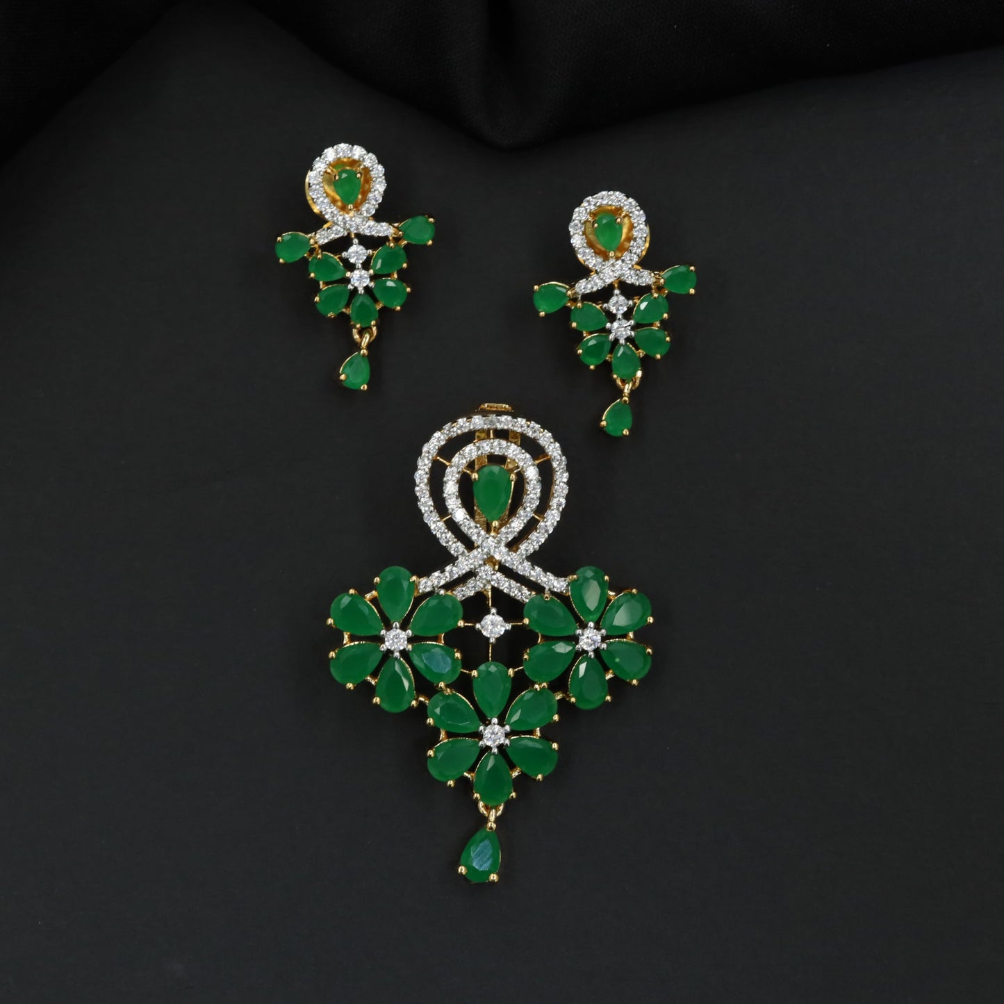 Decorative pendant set with floral craftsmanship and looped centerpiece