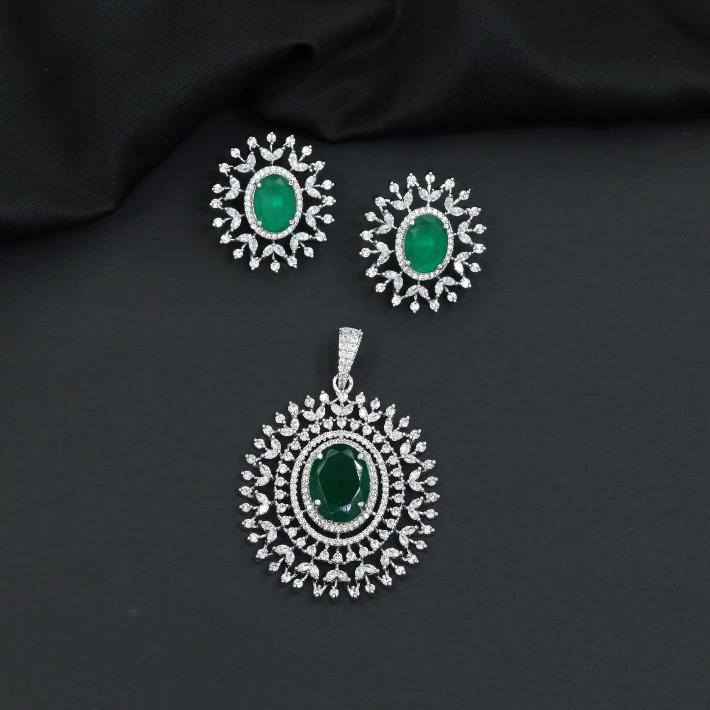 Rhodium finish pendant set with oval drop and radiant border design