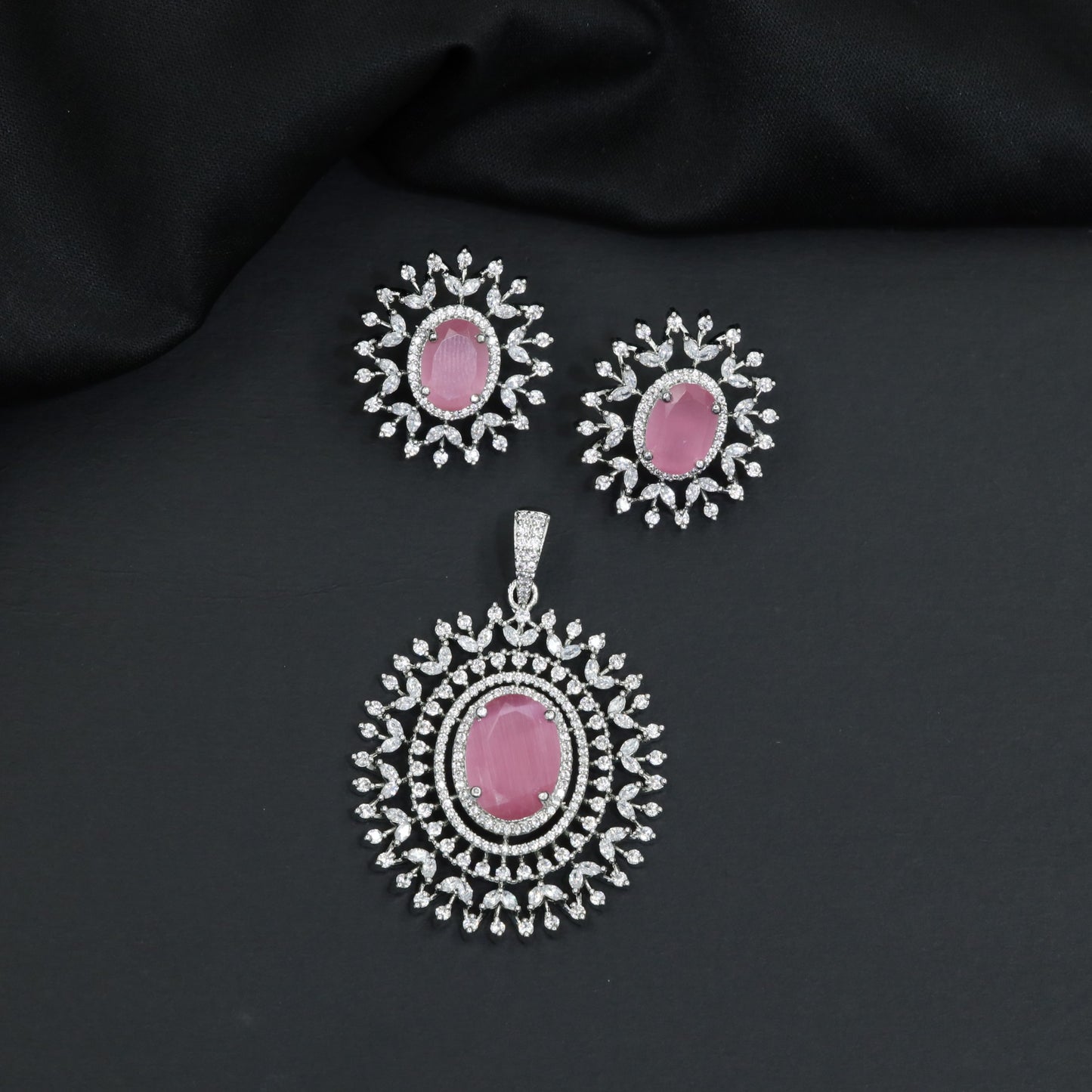Rhodium finish pendant set with oval drop and radiant border design