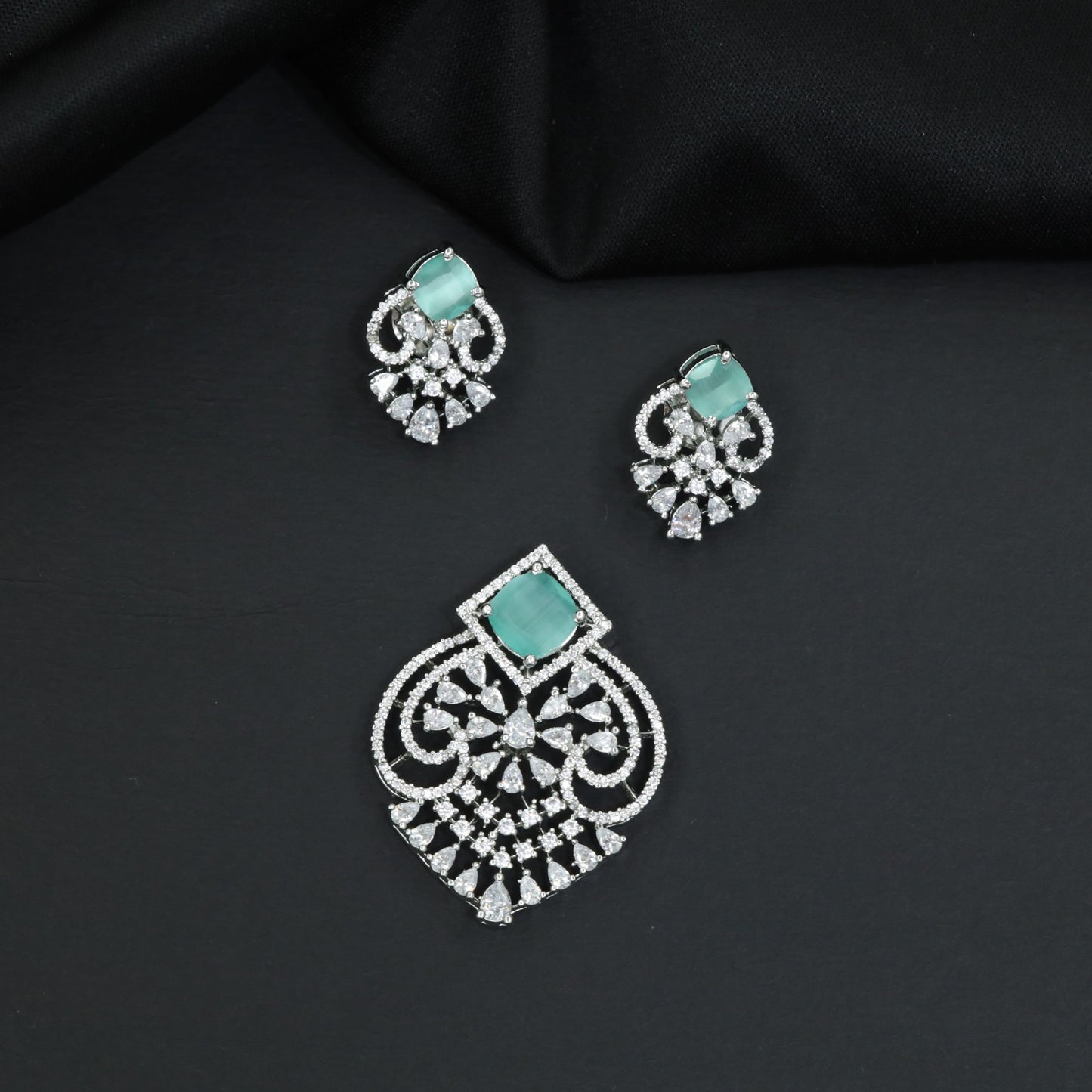 Festive pendant set with ornate openwork patterns and matching earrings
