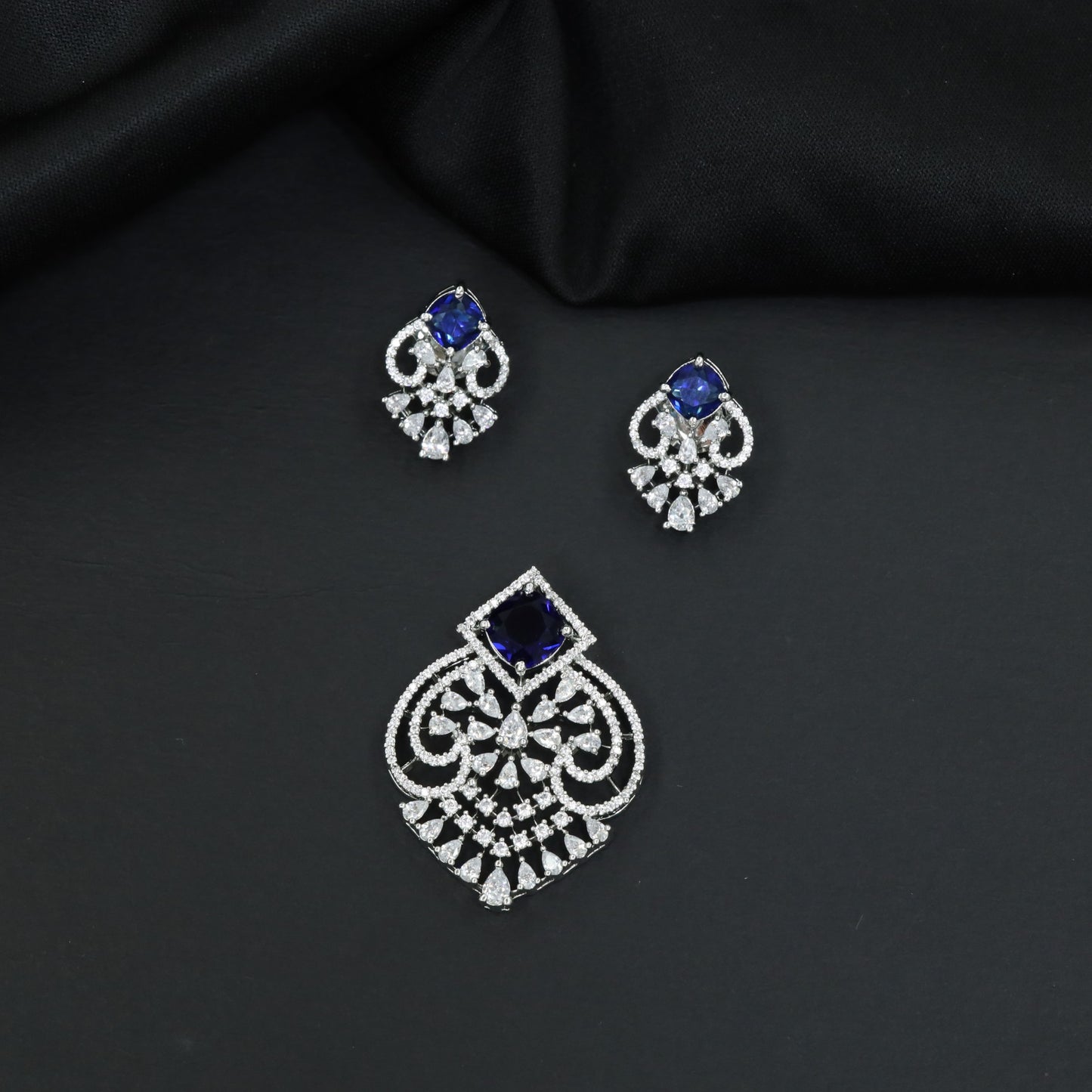 Festive pendant set with ornate openwork patterns and matching earrings