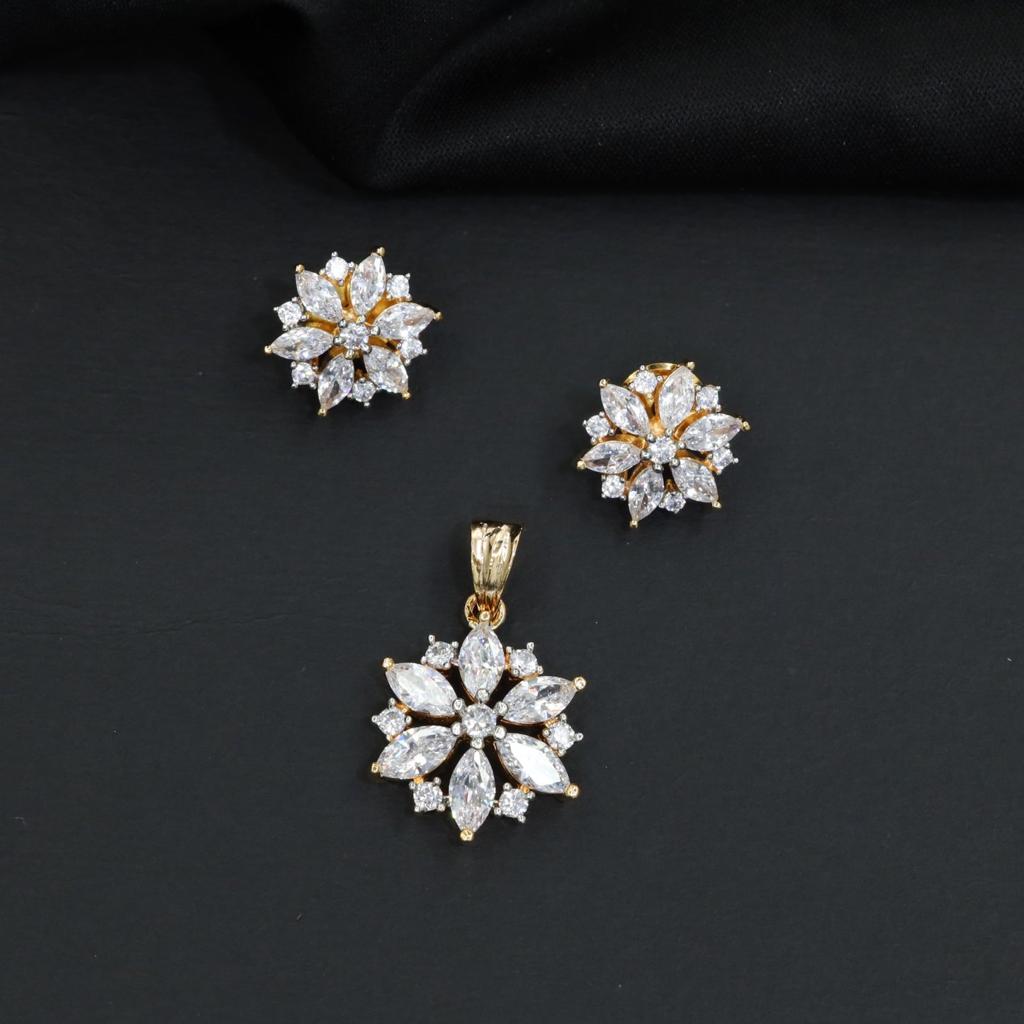 Floral bloom pendant set with marquise petal detailing and matching stud earrings