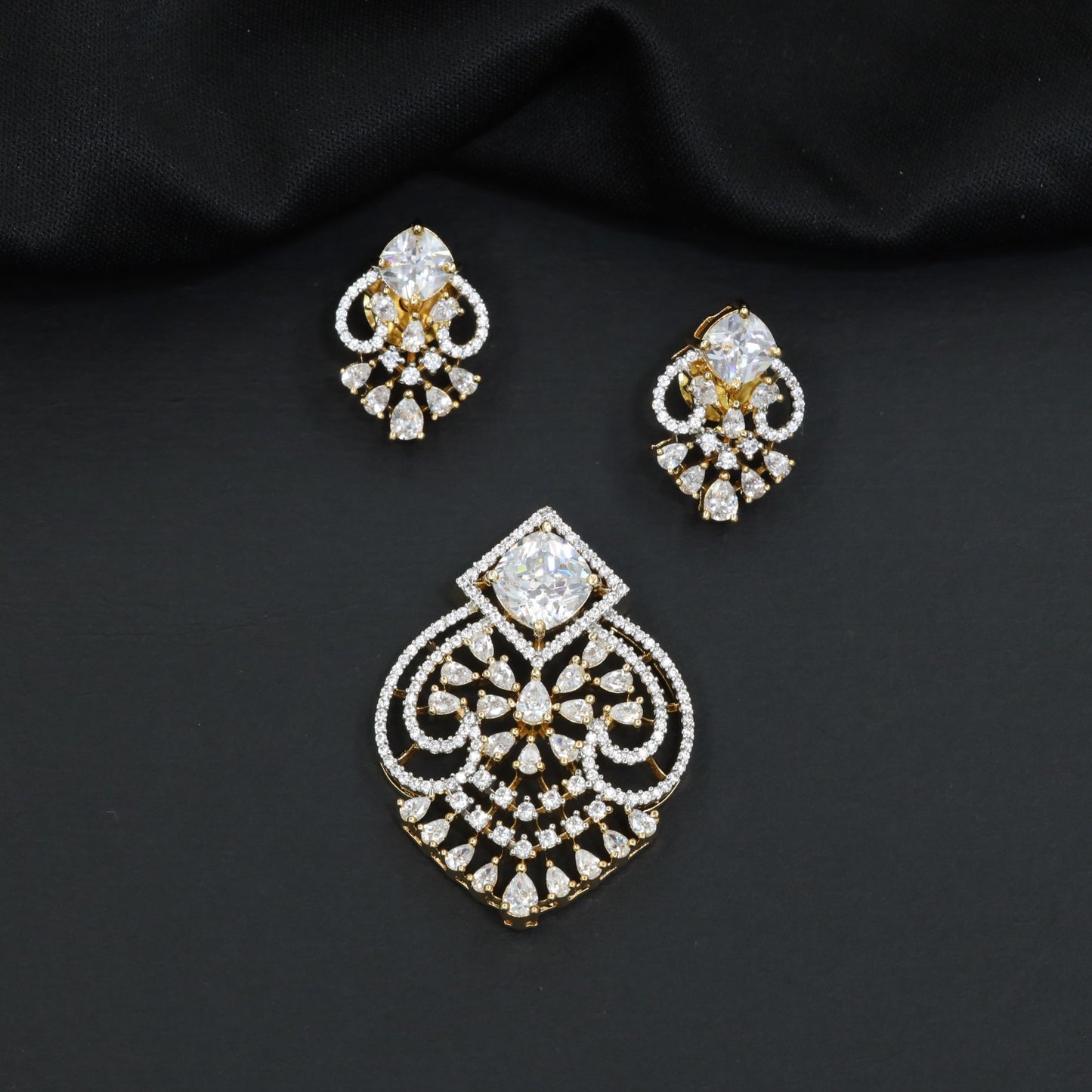 Handcrafted pendant set with floral filigree artistry and teardrop-shaped construction
