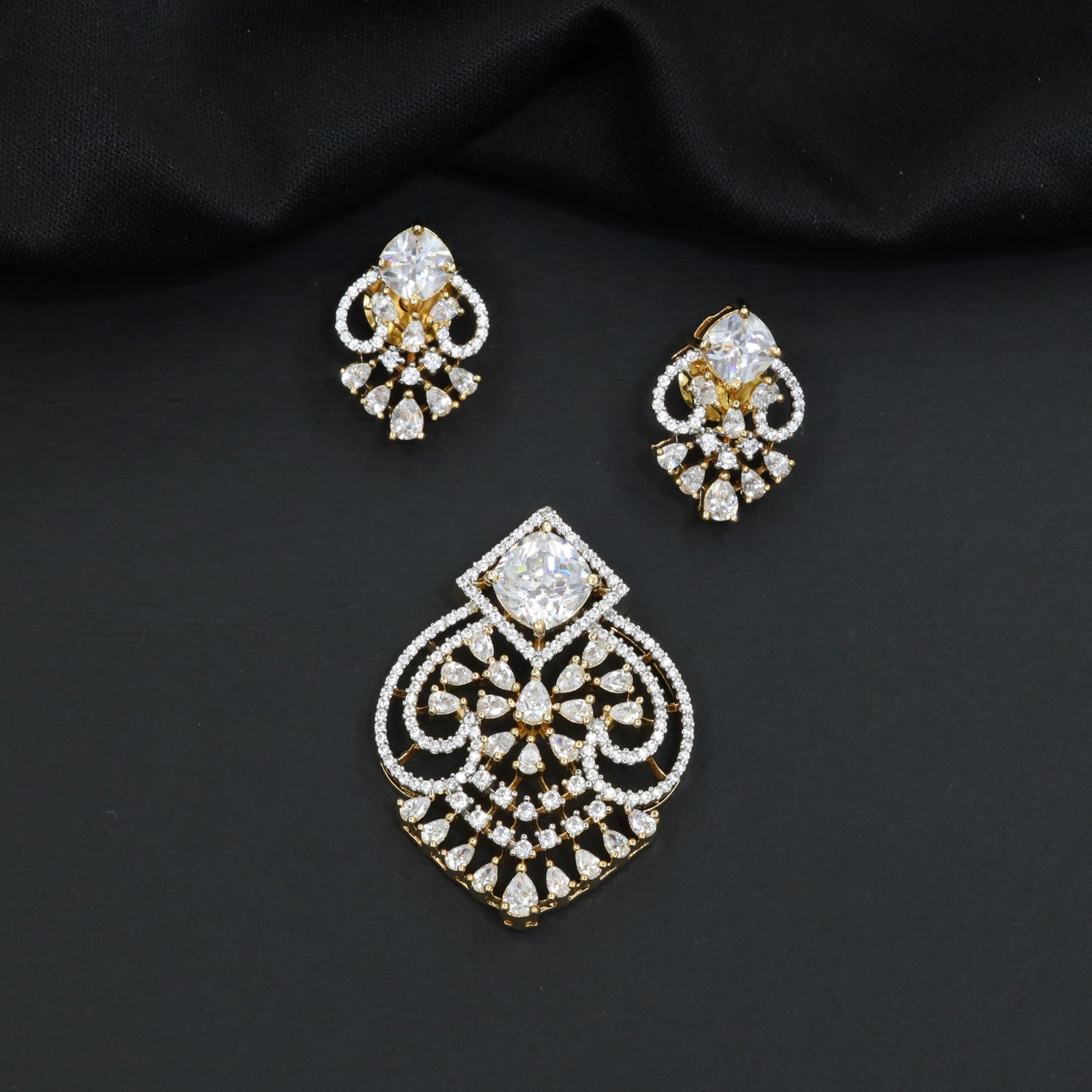 Handcrafted pendant set with floral filigree artistry and teardrop-shaped construction