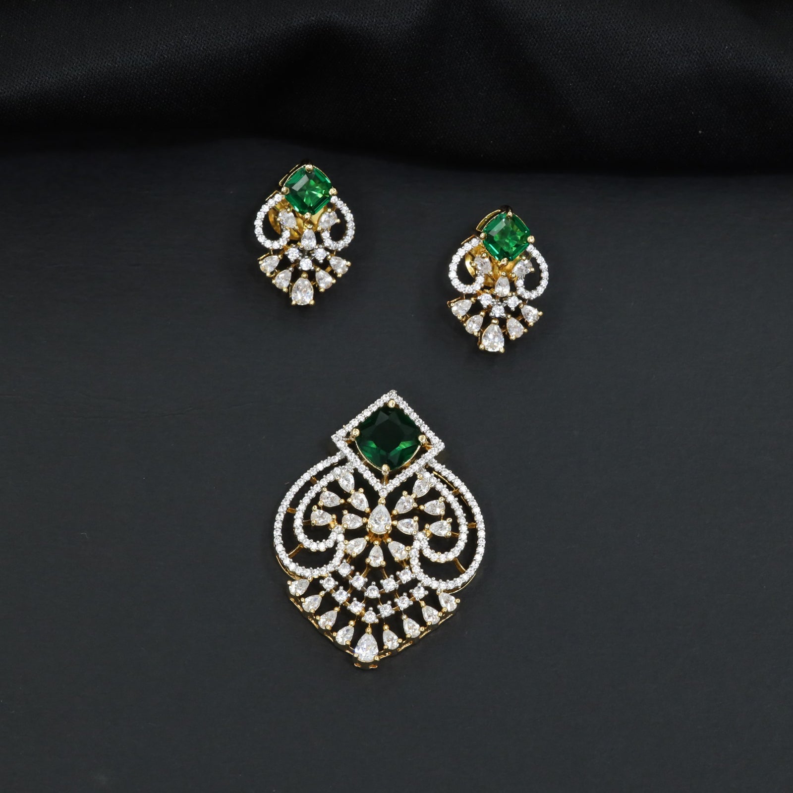 Handcrafted pendant set with floral filigree artistry and teardrop-shaped construction