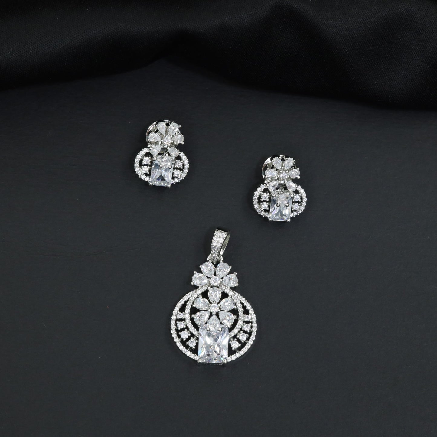 Contemporary floral pendant set showcasing geometric styling and petal cluster accents