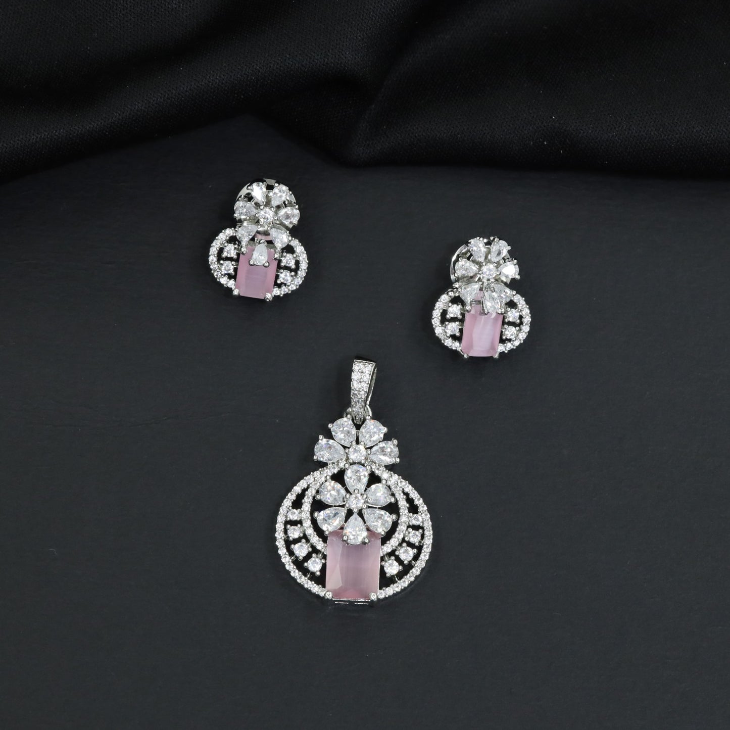 Contemporary floral pendant set showcasing geometric styling and petal cluster accents