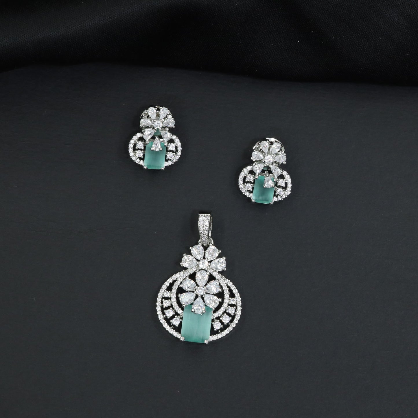 Contemporary floral pendant set showcasing geometric styling and petal cluster accents