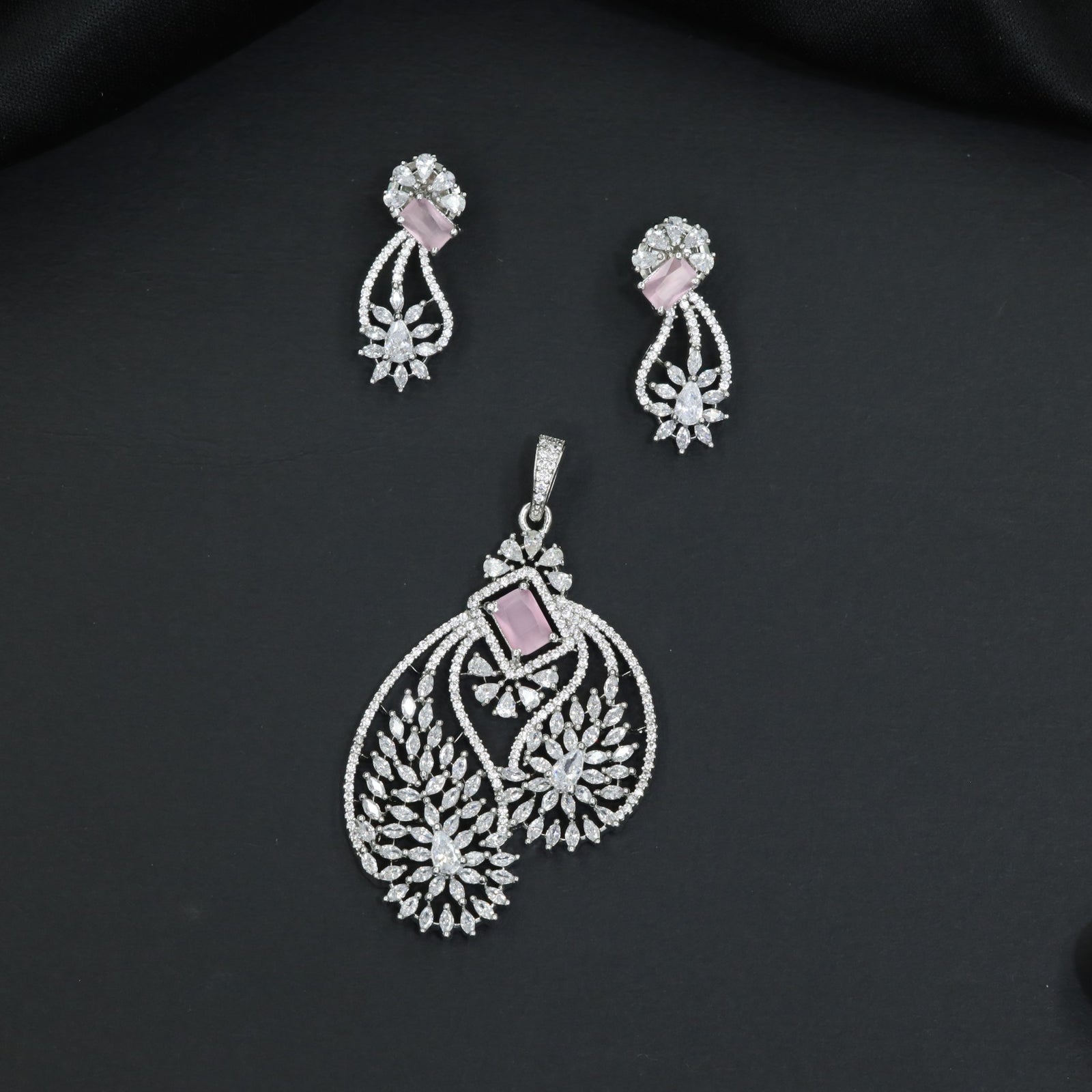 Artistic floral pendant set featuring twin leaf silhouettes and layered flower clusters