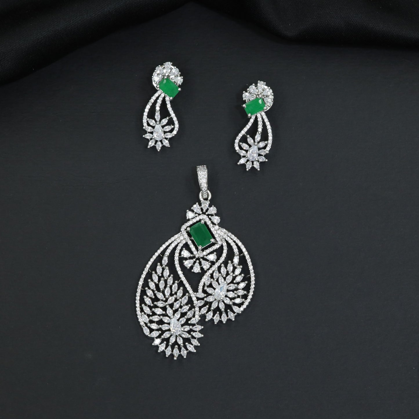 Artistic floral pendant set featuring twin leaf silhouettes and layered flower clusters