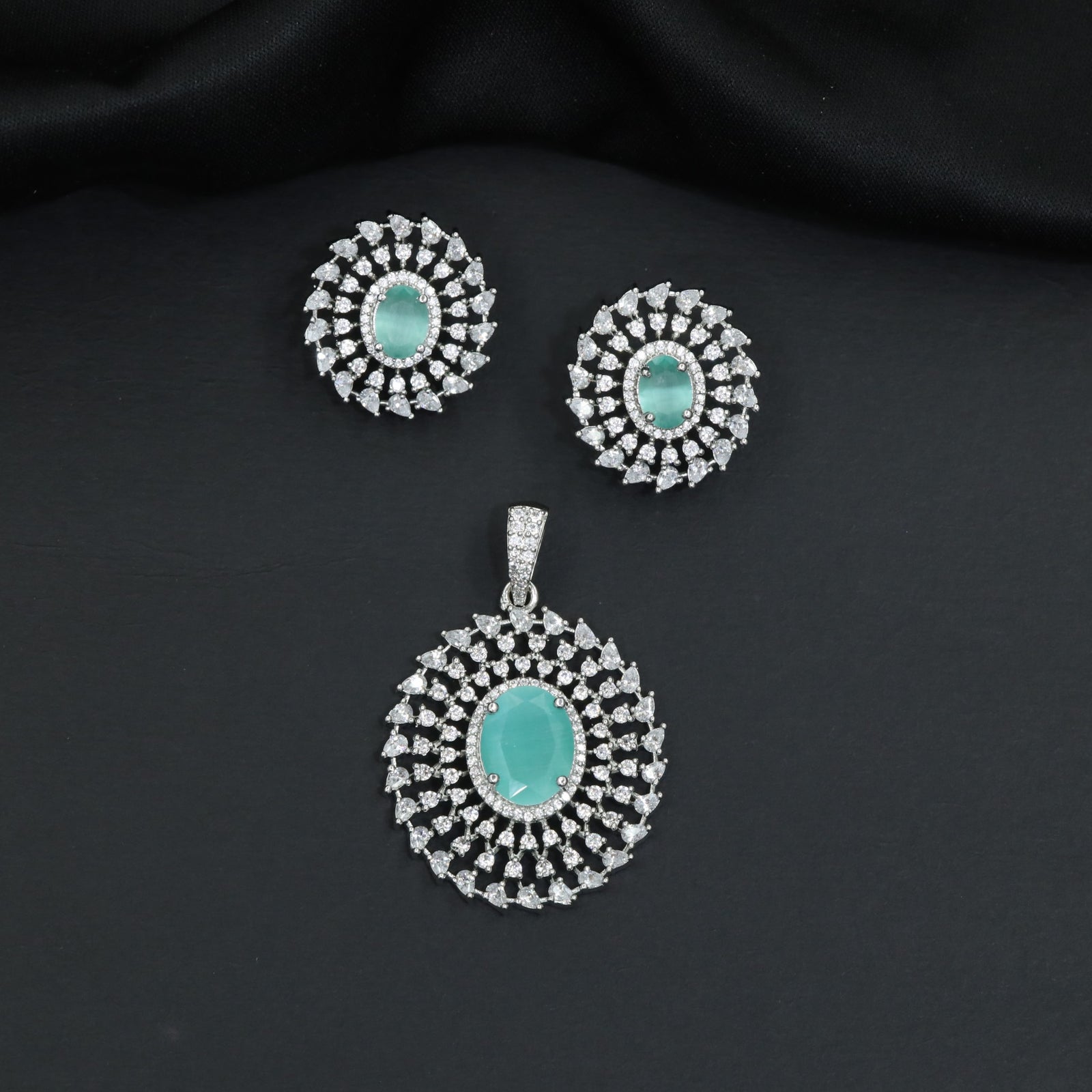 Circular floral pendant set showcasing concentric petal formations and matching studs