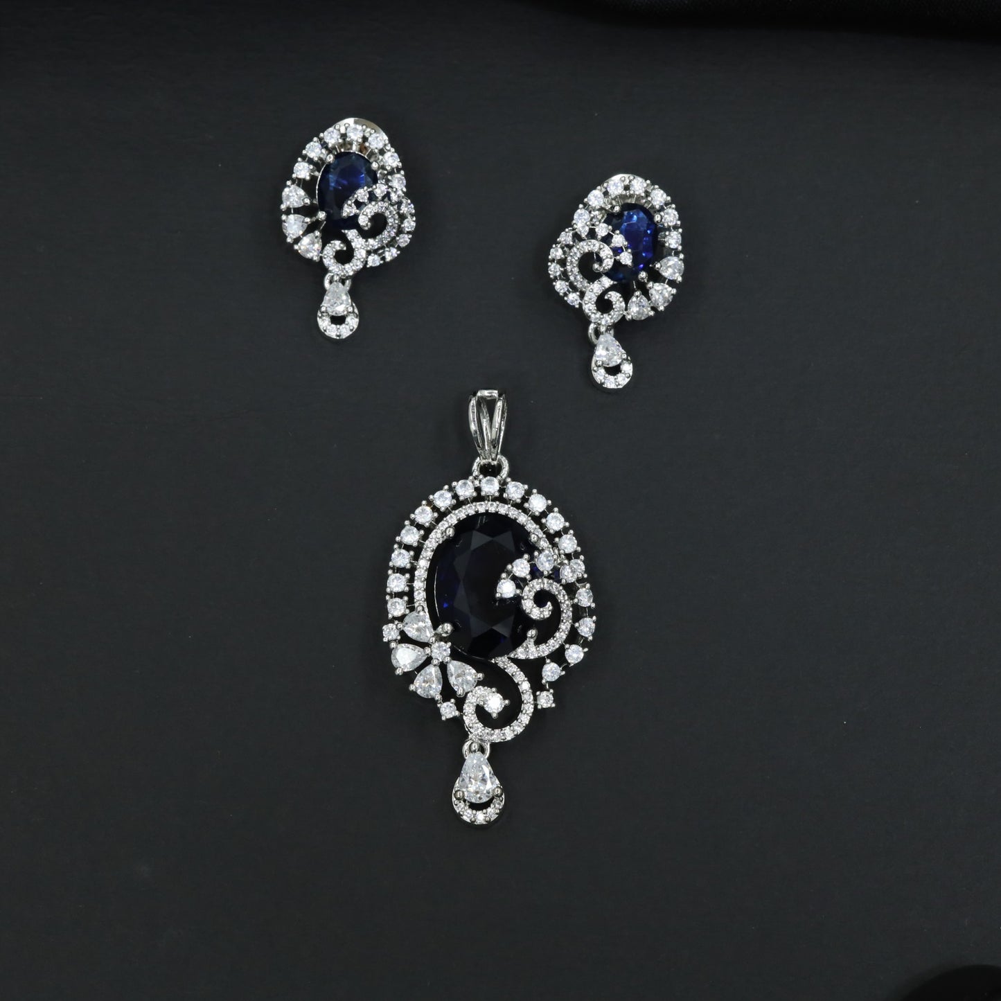 Statement floral pendant set showcasing curved vine craftsmanship and petal clusters