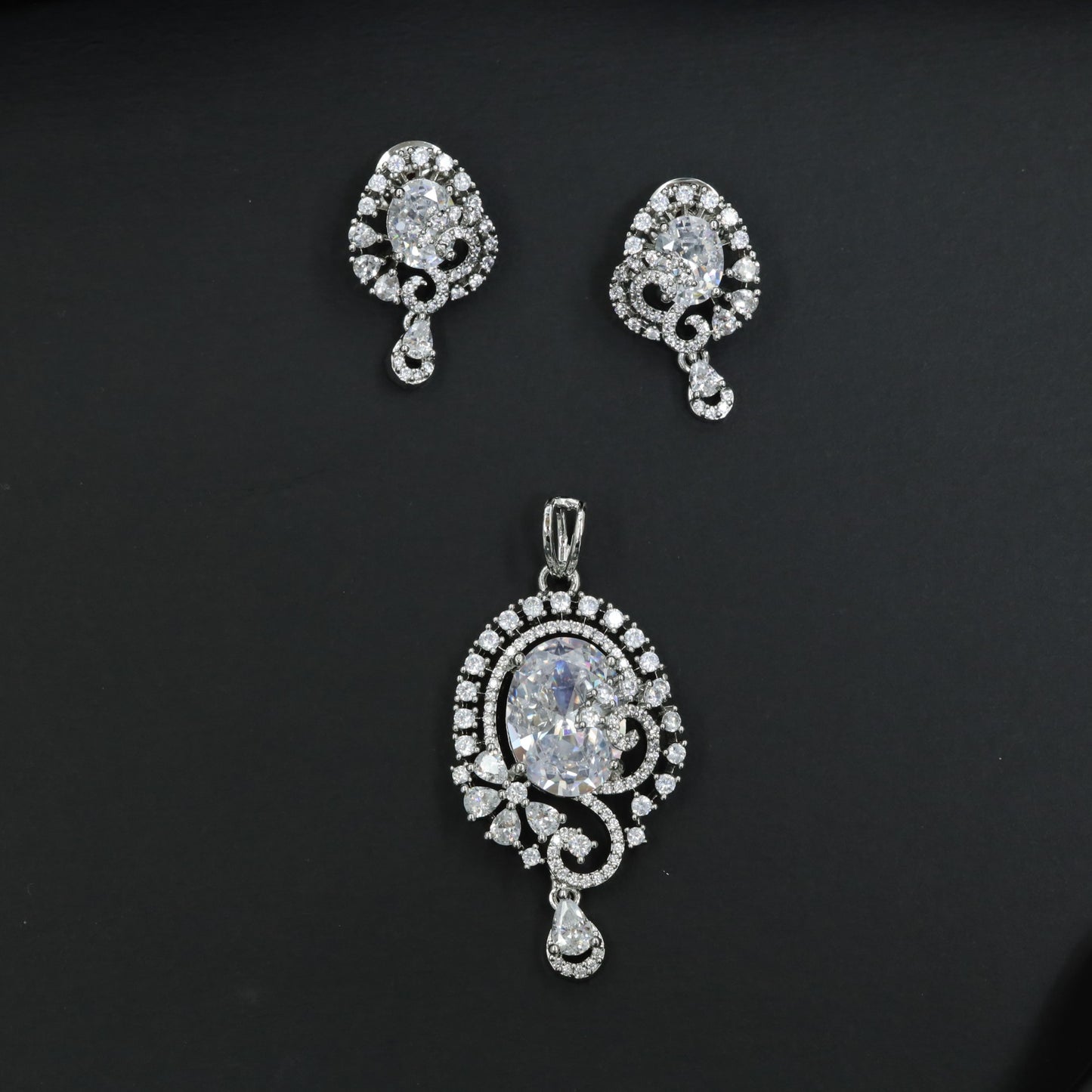 Statement floral pendant set showcasing curved vine craftsmanship and petal clusters