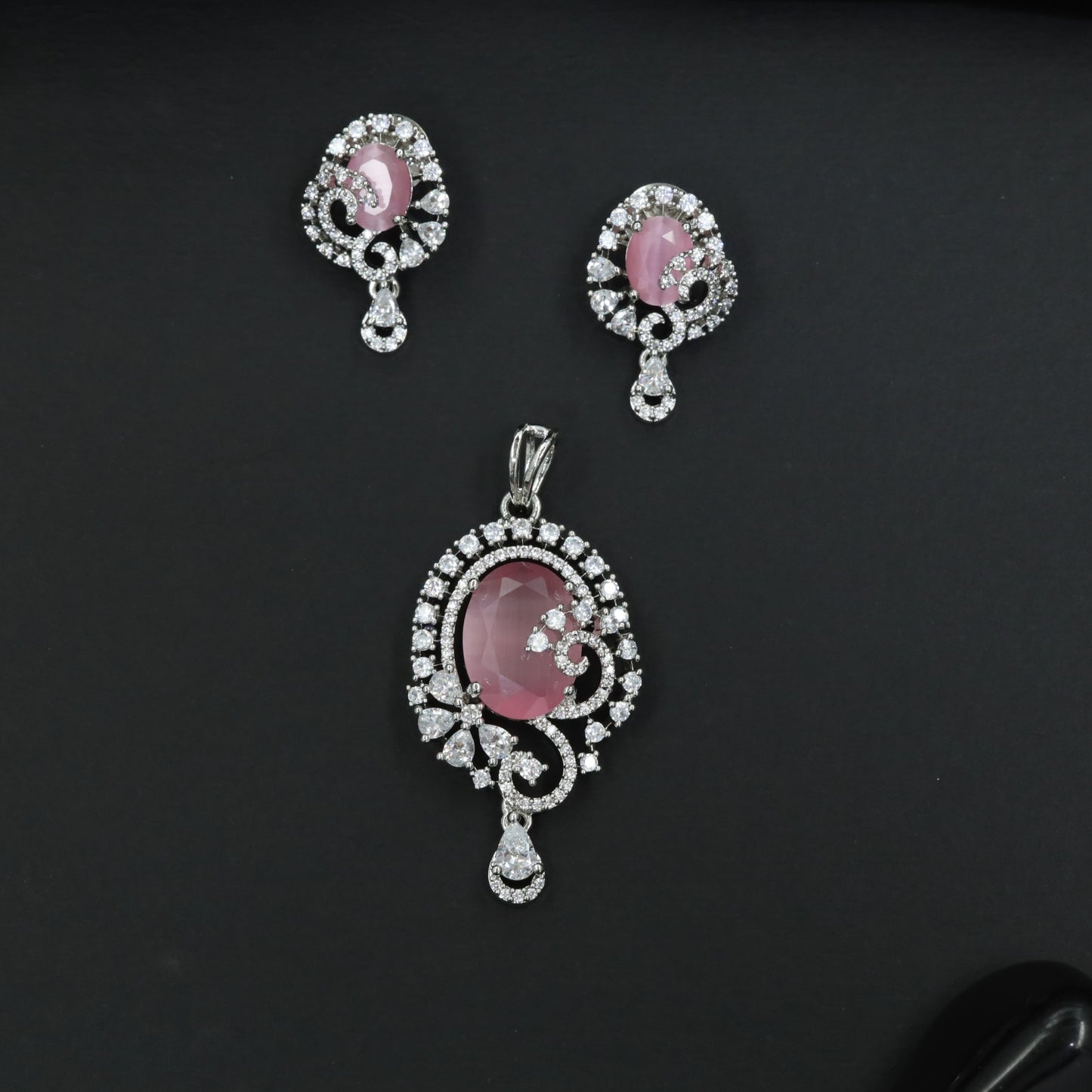 Statement floral pendant set showcasing curved vine craftsmanship and petal clusters