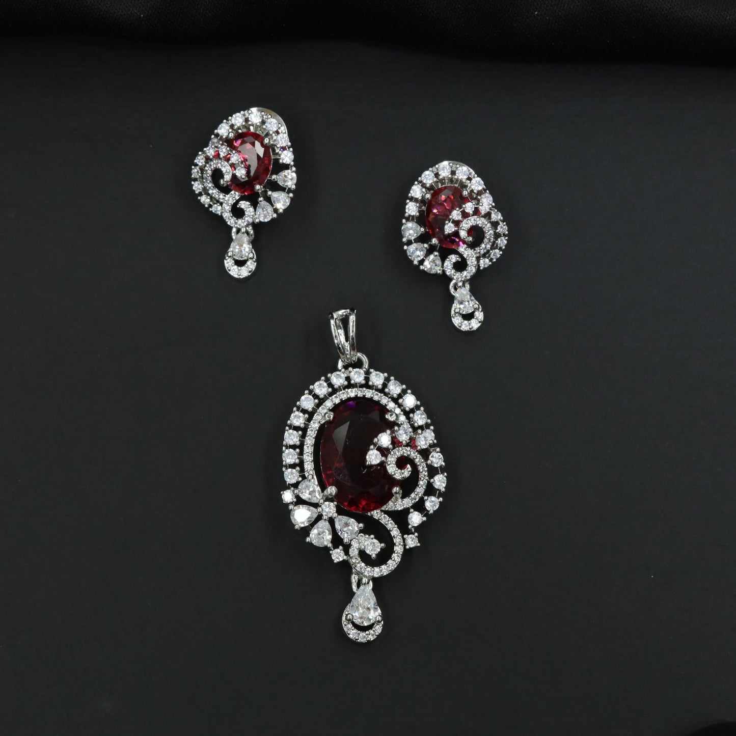 Statement floral pendant set showcasing curved vine craftsmanship and petal clusters
