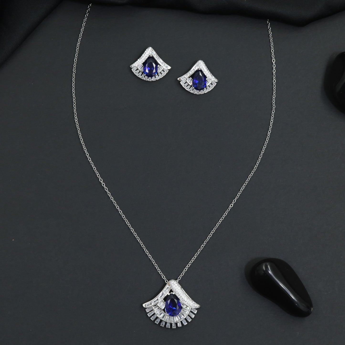 Designer chain with pendant showcasing a fan-inspired silhouette and geometric border detailing