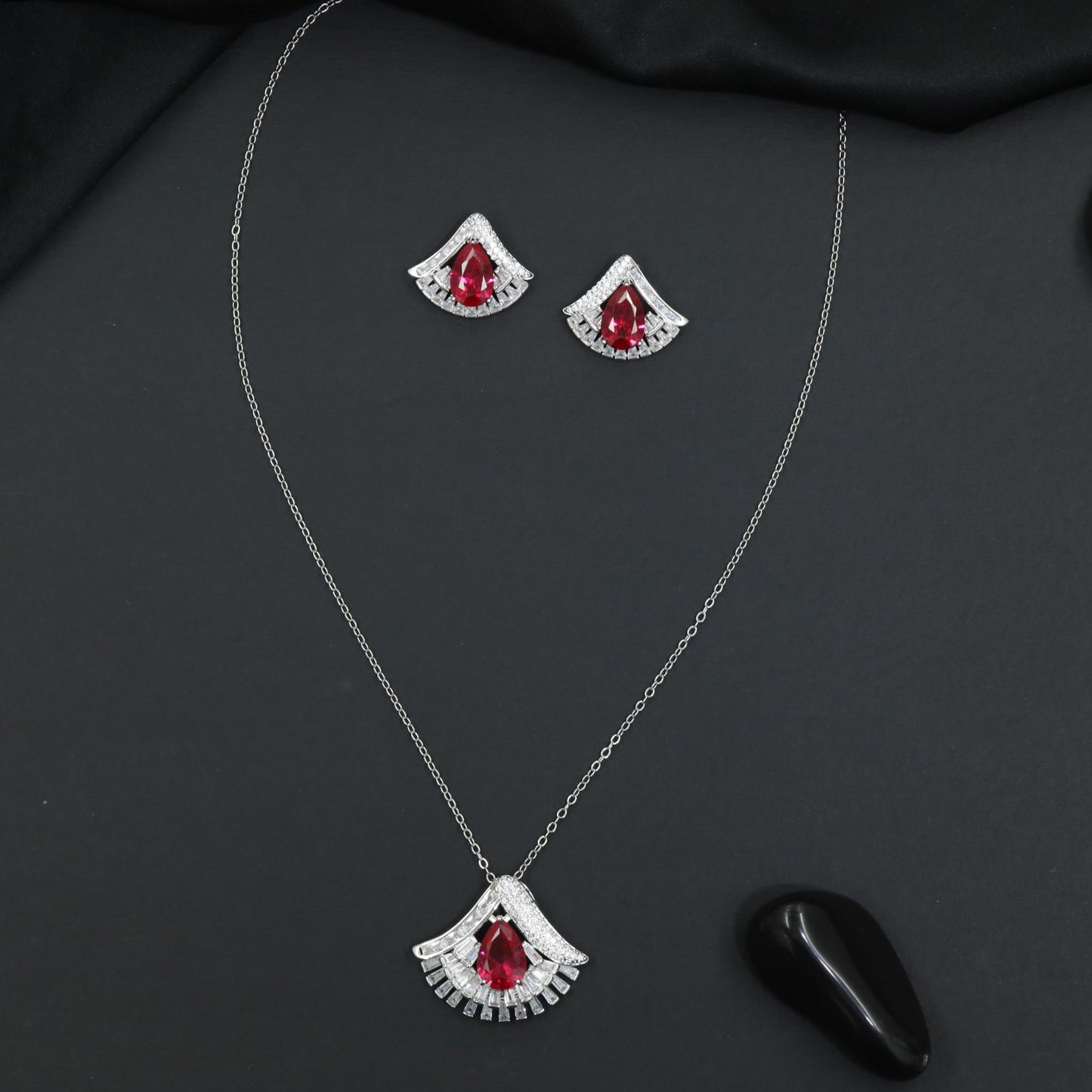Designer chain with pendant showcasing a fan-inspired silhouette and geometric border detailing