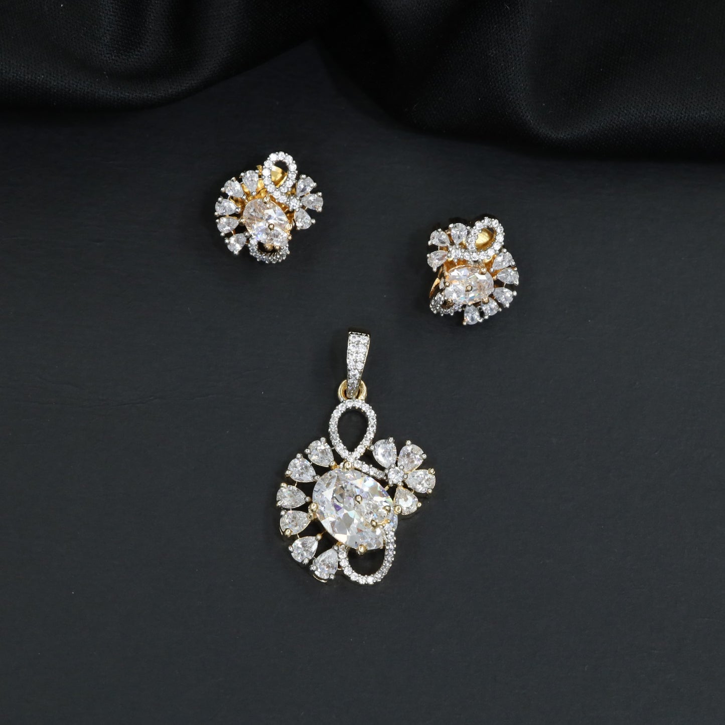 Floral swirl pendant set with leaf cluster detailing and matching stud earrings