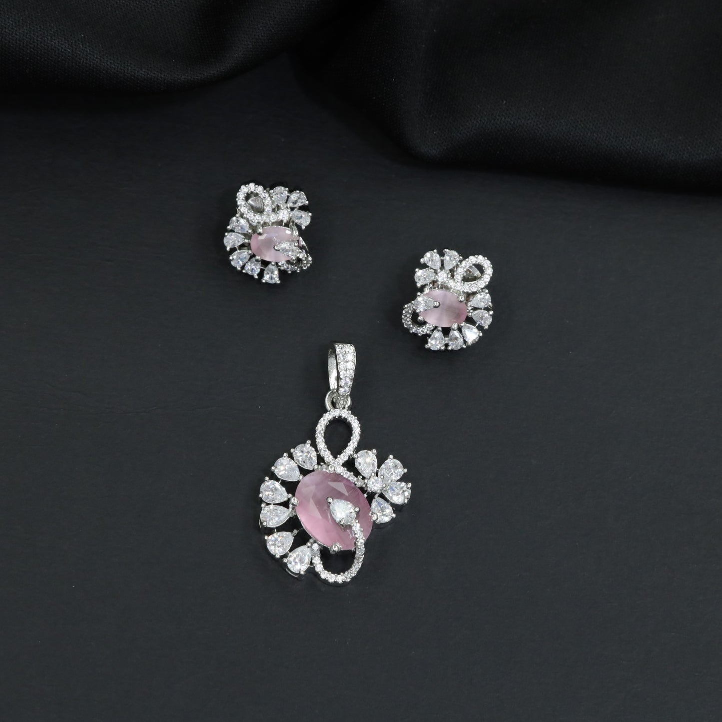 Floral swirl pendant set with leaf cluster detailing and matching stud earrings