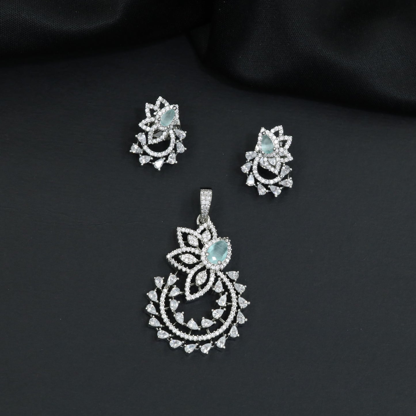 Designer pendant set showcasing a flower silhouette with cascading leaf accents