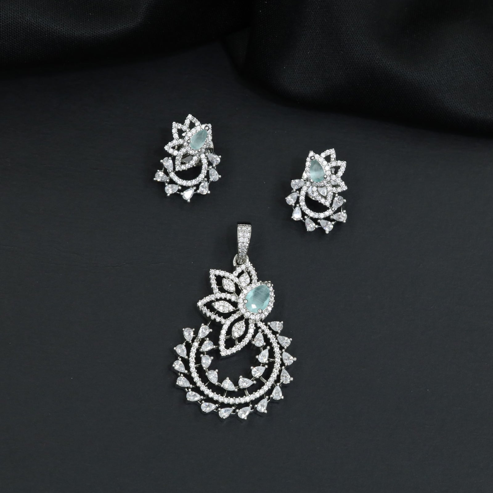 Designer pendant set showcasing a flower silhouette with cascading leaf accents