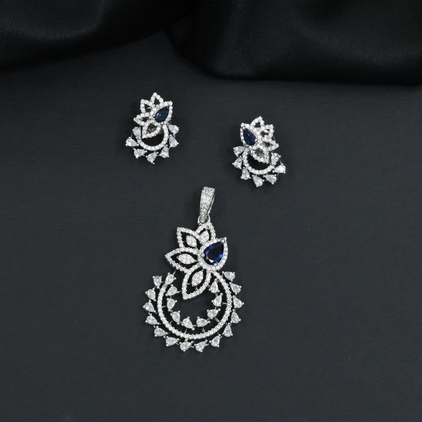Designer pendant set showcasing a flower silhouette with cascading leaf accents