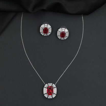 Contemporary pendant chain set with a structured medallion profile and matching stud earrings