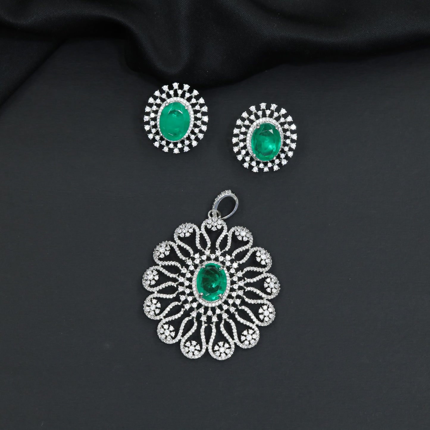 Grand flower pendant set featuring an oval centerpiece and scalloped petal arrangement