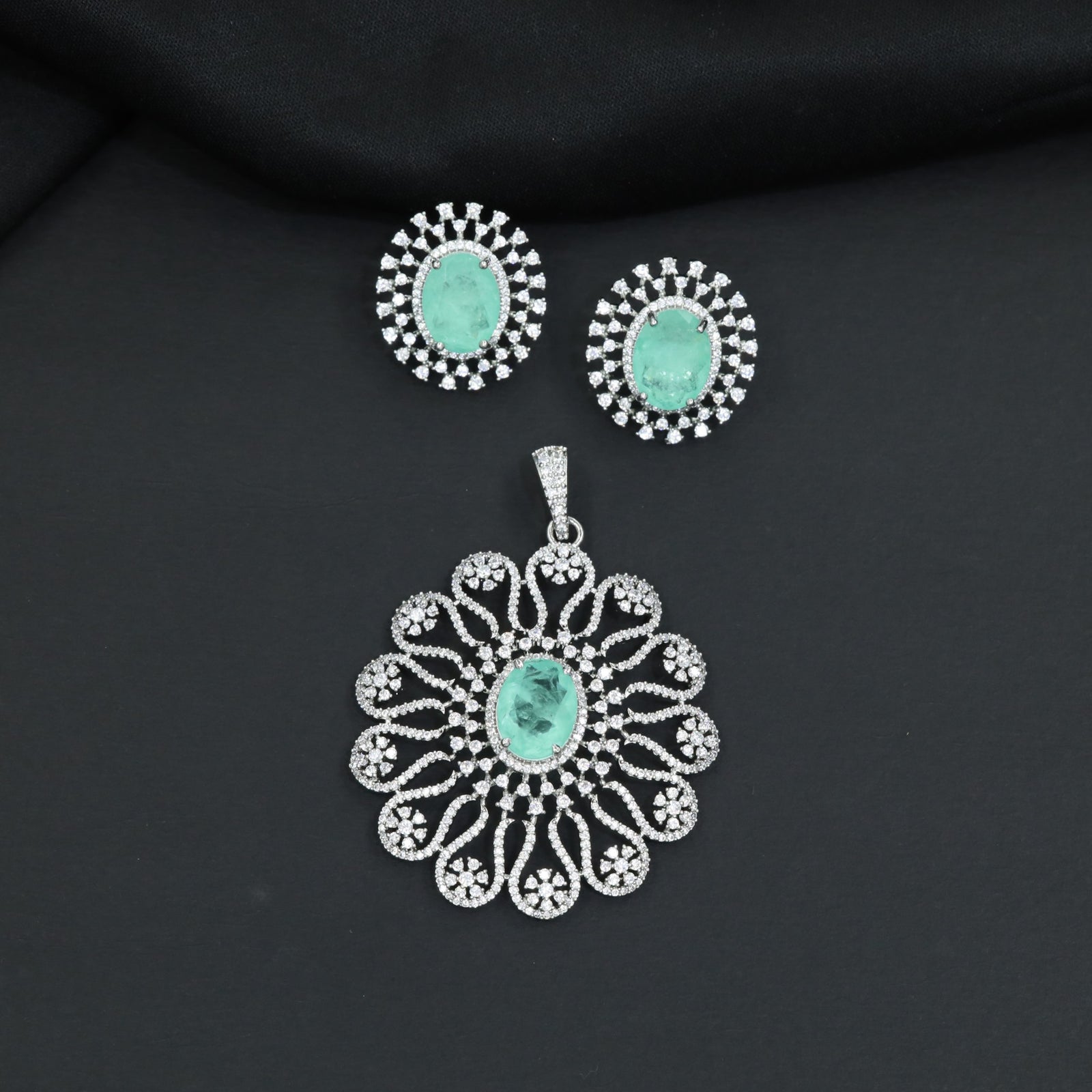 Grand flower pendant set featuring an oval centerpiece and scalloped petal arrangement
