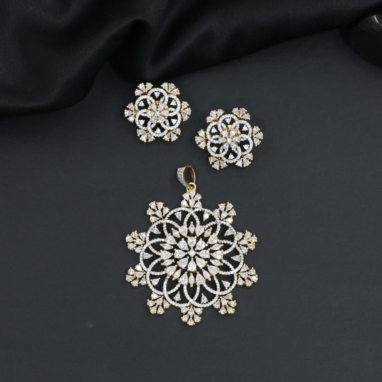 Mandala-inspired pendant set with intricate openwork pattern and floral accents