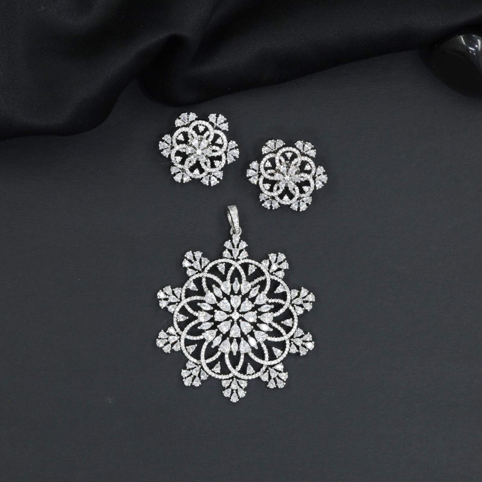 Mandala-inspired pendant set with intricate openwork pattern and floral accents