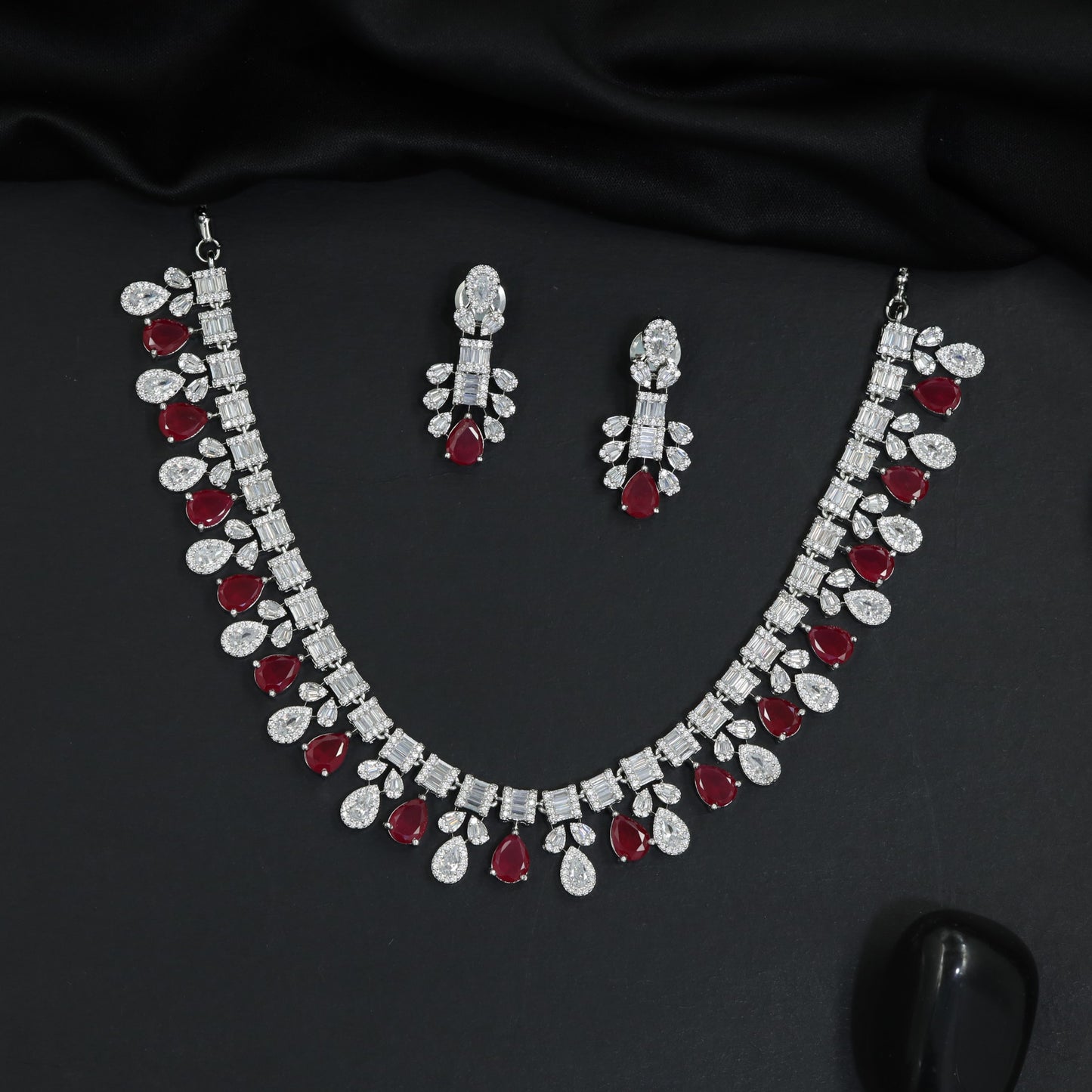 Imperial rhodium finish decorative necklace with a central cascading teardrop crest
