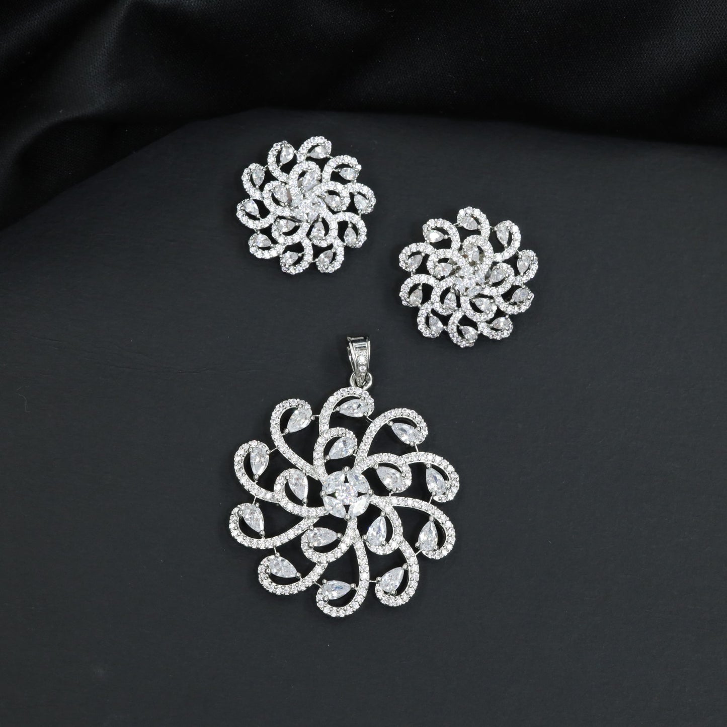Elegant pendant set with swirling floral framework