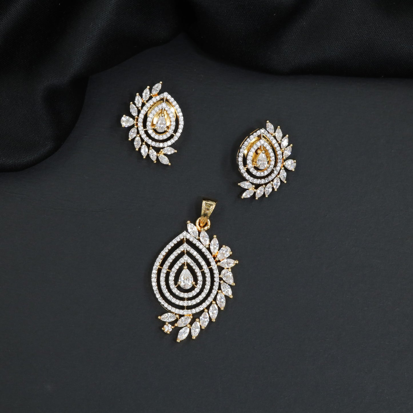 Graceful marquise stone leaf accented pendant set with stone paved top bail