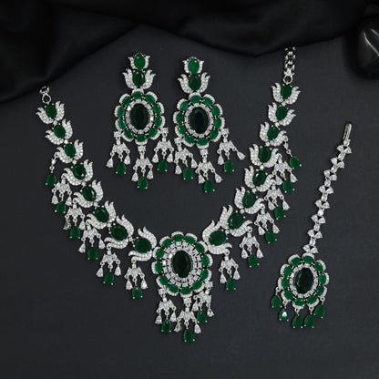 Traditional sweeping tulip motif rhodium necklace set with a central oval rosette drop