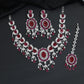 Traditional sweeping tulip motif rhodium necklace set with a central oval rosette drop