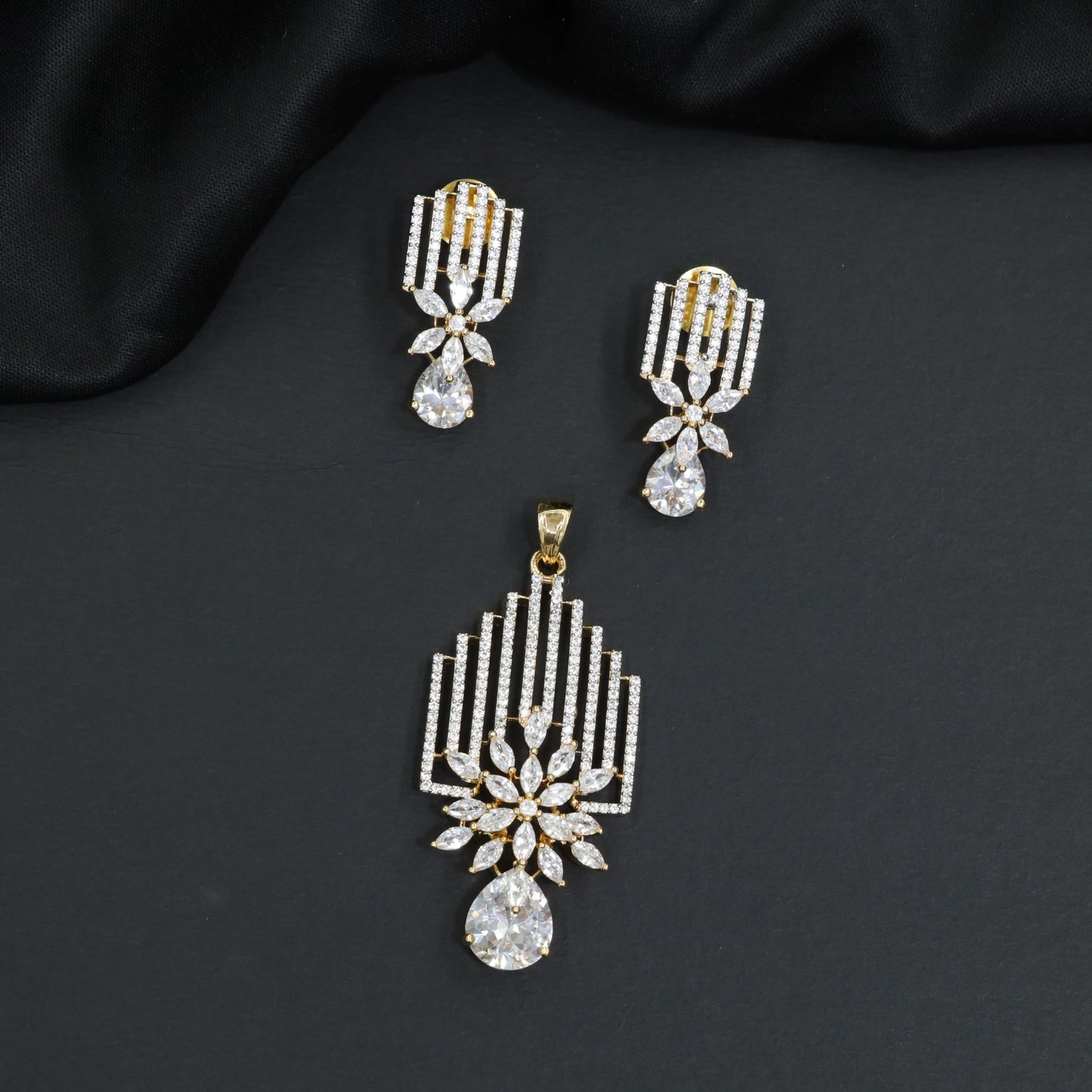 Classic rosette pendant with vertical stone stripes and prominent pear cut dangle