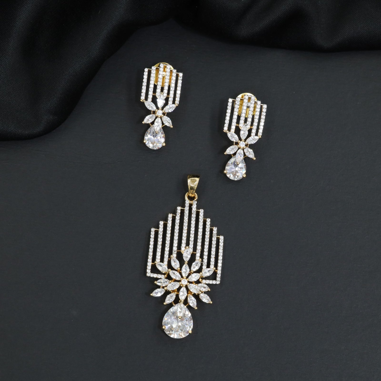 Classic rosette pendant with vertical stone stripes and prominent pear cut dangle